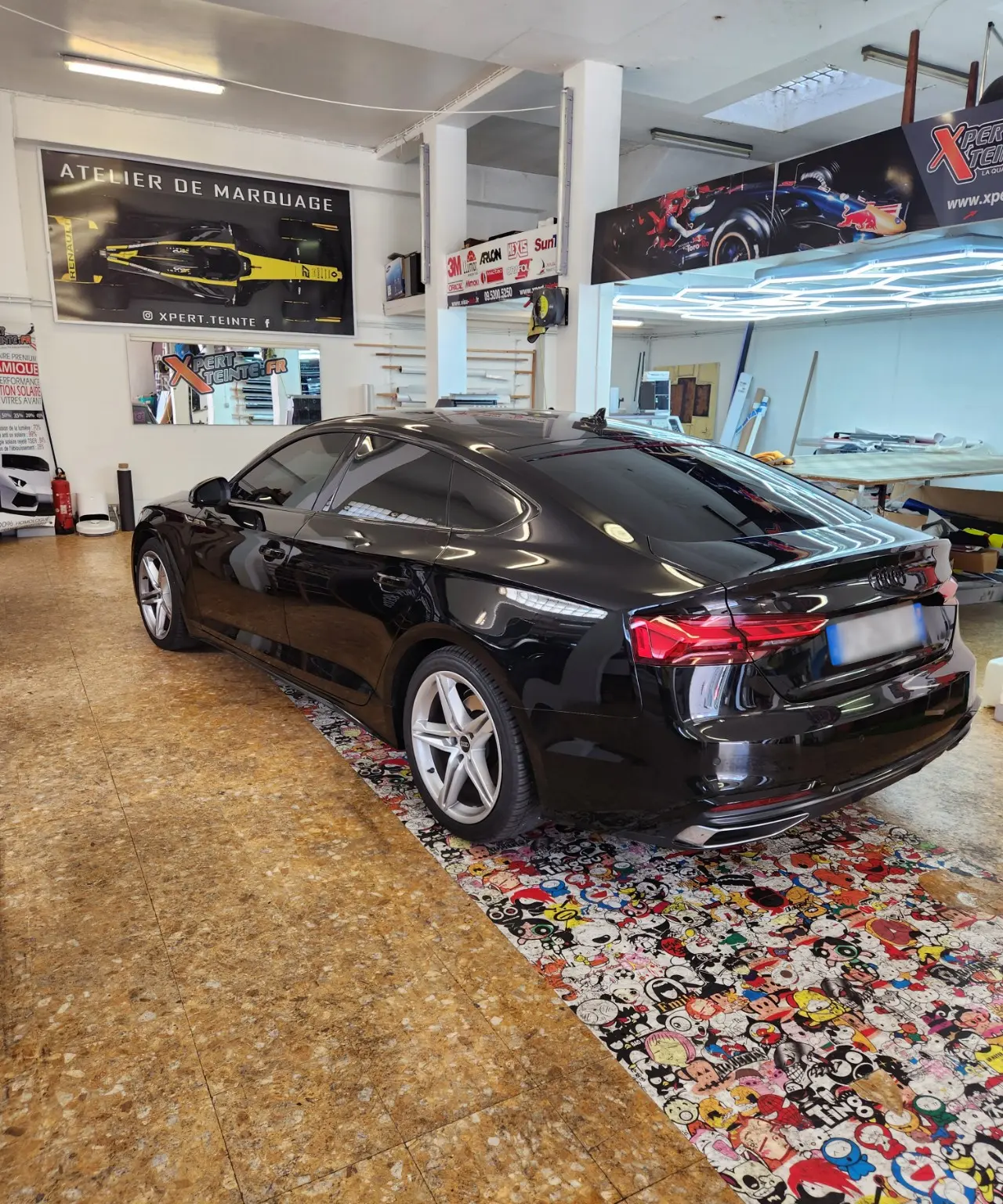 Audi A5 Sportback noire, vitres latérales et lunette arrière teintées, dans l’atelier Xpert Teinte à Toulon.